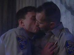 Horny policemen kiss each other